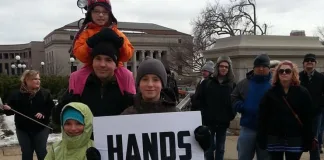 A family from Burnsville attended a rally at the State Capitol to oppose upcoming hearings on gun control legislation. Photo by nick coleman
