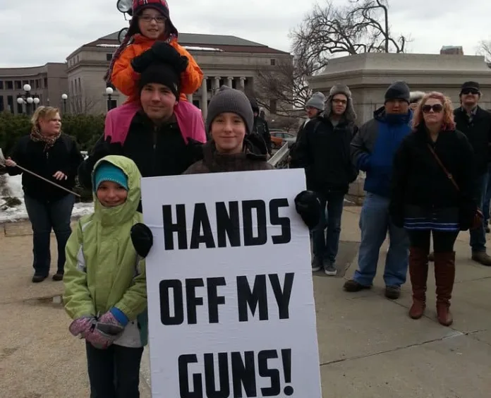 A family from Burnsville attended a rally at the State Capitol to oppose upcoming hearings on gun control legislation. Photo by nick coleman