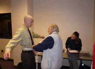 Taking measurements for body armor.