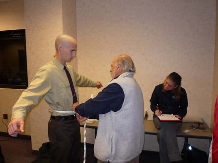 Taking measurements for body armor.