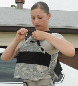 Pfc. Misty Ortiz, adjusts the new covert military female body armor during testing.