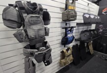 From the Streets to the Lab: How Real-World Threats Are Shaping the Future of Body Armor A tactical mannequin wearing modern camouflage body armor and helmet is displayed at a defense exhibition booth, illustrating the latest advancements in body armor innovation and protective gear for military and law enforcement.